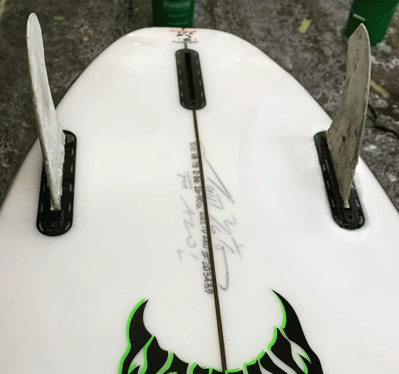 Photo of a surfboard with fin boxes being routed properly. 